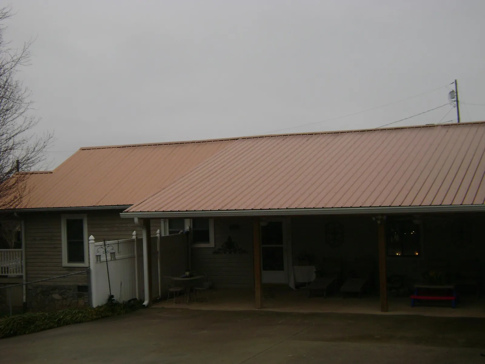 Copper toned metal roof over a wide covered patio in Pomona
